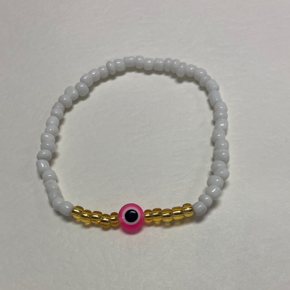 Handmade White and Gold Beaded Bracelet with Pink Evil Eye Accent